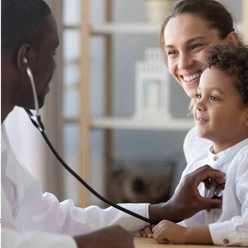 Doctor with a stethoscope examining a young boy